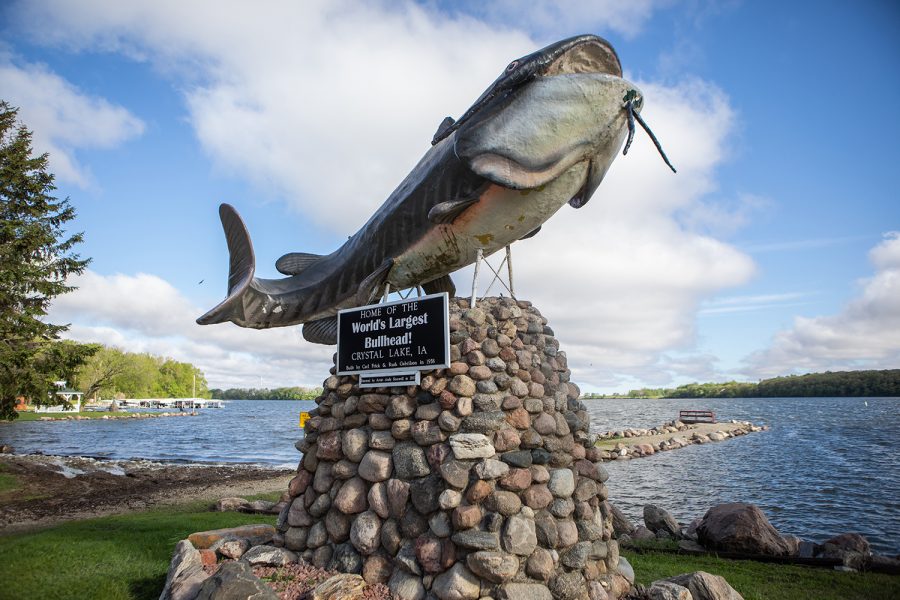 A sculpture of a bullhead catfish is positioned near the shore of Crystal Lake in the town of Crystal Lake, Iowa, on May 20, 2019. The plaque underneath the fish is captioned, “Home of the World’s Largest Bullhead: Crystal Lake, IA. The nitrate test of Crystal Lake was approximately 25 mg/L. The EPA recommends nitrate levels below 10 mg/L for consumable groundwater. If levels rise above 10 mg/L, it poses hazards for human consumption and wildlife habitats downstream.