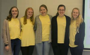 University of Iowa students Audrey Wood, Kenzie Busch, Jordyn Meyer, Paige Kehrli, and Samantha Reed pose for a group photo next to a presentation used for the birth to five course in the Wendell Johnson Speech and Hearing Clinic on Monday, May 6, 2019. 