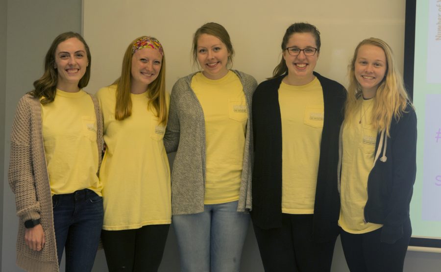 University of Iowa students Audrey Wood, Kenzie Busch, Jordyn Meyer, Paige Kehrli, and Samantha Reed pose for a group photo next to a presentation used for the birth to five course in the Wendell Johnson Speech and Hearing Clinic on Monday, May 6, 2019. 