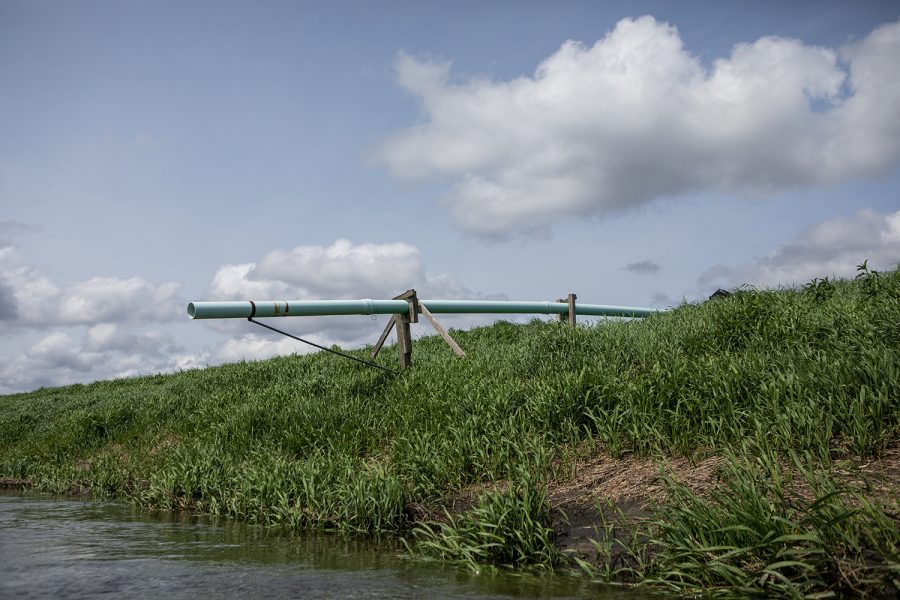 A drainage pipe stands on the riverbank of the Iowa River’s west branch on May 20, 2019. This pipe is one of several drainage solutions for excess water in Iowa farmlands and communities. 