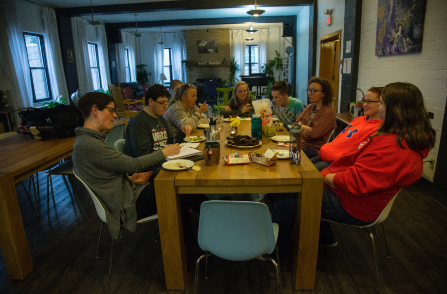 Rev. Anna Blaedel leads Tuesday Table at the Wesley Center on April 30. Students ate dinner, talked about their week, and threw seed pods into the garden. 
