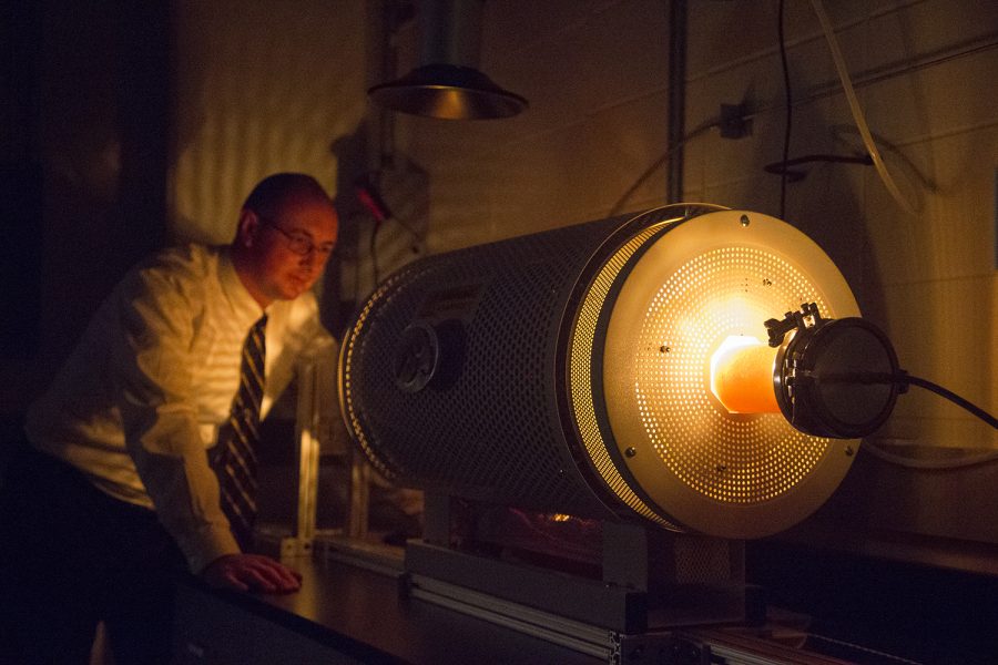 Space physicist David Miles is seen with a furnace that melts metal that is part of an important magnetic field instrument on Friday, May 3, 2019. The fluxgate magnetometer is used for measuring low-frequency magnetic fields during space missions. 