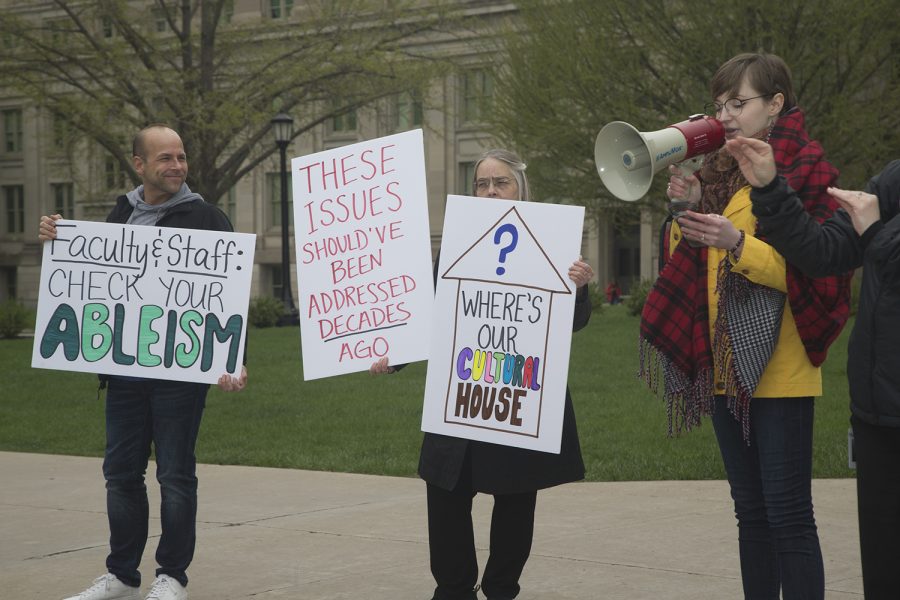 Karina Foster-Middleton speaks about the importance of disability advocacy while attendees hold signs on the Pentacrest on Wednesday, May 1, 2019. UI Students for Disability Advocacy & Awareness organized this rally to speak about the injustice that students with disabilities face on campus.