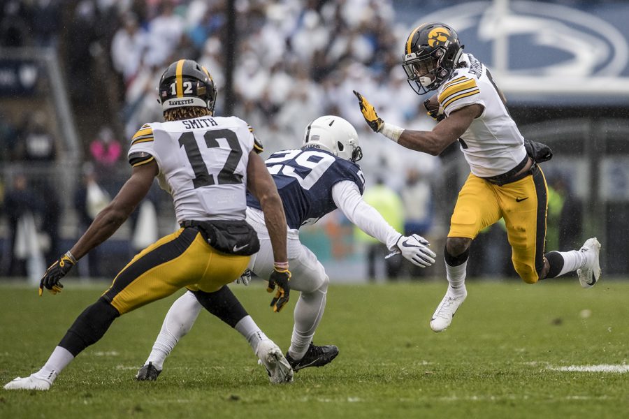 Iowa+wide+receiver+Ihmir+Smith-Marsette+avoids+a+defender+during+Iowas+game+against+Penn+State+at+Beaver+Stadium+on+Saturday%2C+October+27%2C+2018.+The+Nittany+Lions+defeated+the+Hawkeyes+30-24.