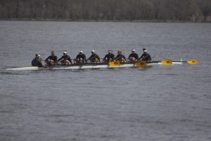 The Iowa varsity 8 crew looks to their supporters on the shore as they row back to the dock at the end of the first session of a womens rowing meet on Lake MacBride on Saturday April 13, 2019. Iowa won 3 out of 12 races with the varsity 8 crew winning both races for the day. 