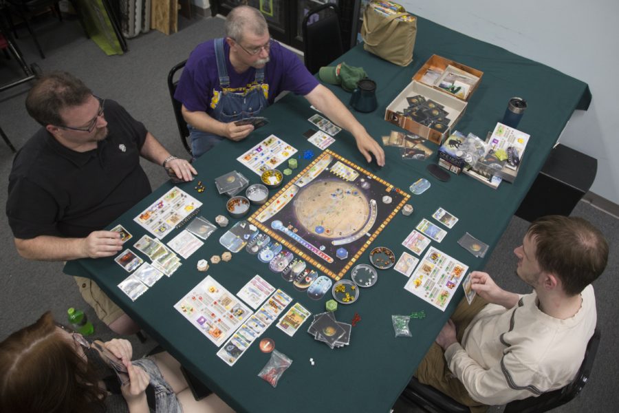 Board+game+club+attendees+play+a+game+at+Hobby+Corner+located+in+the+Sycamore+Mall+on+Thursday%2C+June+6%2C+2019.+%28Emily+Wangen%2FThe+Daily+Iowan%29