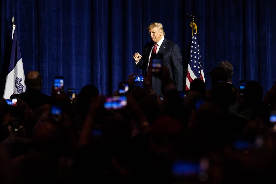 President Donald Trump walks to the podium during the Iowa GOP’s America First Dinner at the Ron Pearson Center in West Des Moines on Tuesday, June 11, 2019. (Wyatt Dlouhy/The Daily Iowan)