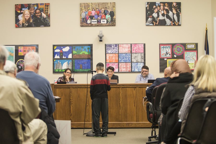 A young attendee speaks to the school board during an Iowa City school board meeting at the Professional Development Center on March 27, 2018. (Katina Zentz/The Daily Iowan)