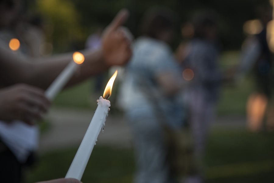 Participants hold lighted candles during the “Lights for Liberty: Vigil to End Human Concentration Camps” at College Green Park on Friday, July 12, 2019. (Tian Liu/The Daily Iowan)