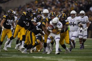 Northwestern running back Isaiah Bowser is tackled by Iowa defense during the Iowa/Northwestern football game at Kinnick Stadium on Saturday, November 10, 2018. 