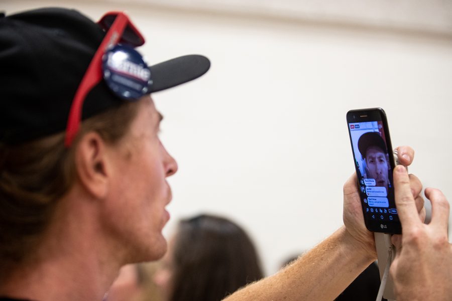 A supporter live streams to 46 followers on Facebook after the event on Tuesday, July 2, 2019, at the Robert A. Lee Recreation Center in Iowa City, Iowa.