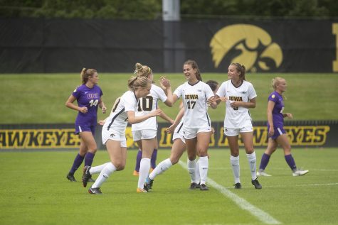 Iowa team members high five each other following a goal during a match against the University of Northern Iowa Panthers on Sunday, August 25, 2019. The Hawkeyes defeated the Panthers 6-1. (Emily Wangen/The Daily Iowan)