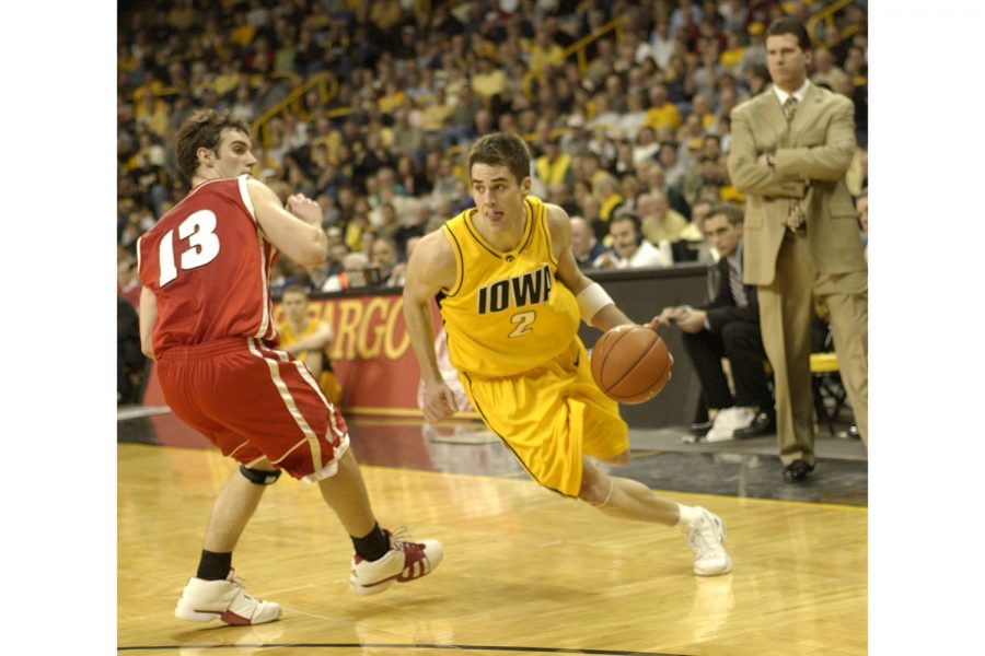 Ben Roberts/The Daily Iowan
University of Iowa starting point guard Jeff Horner flies past Wisconsins Clayton Hanson during a 54-52 loss to the Badgers on Wednesday evening in Iowa City.