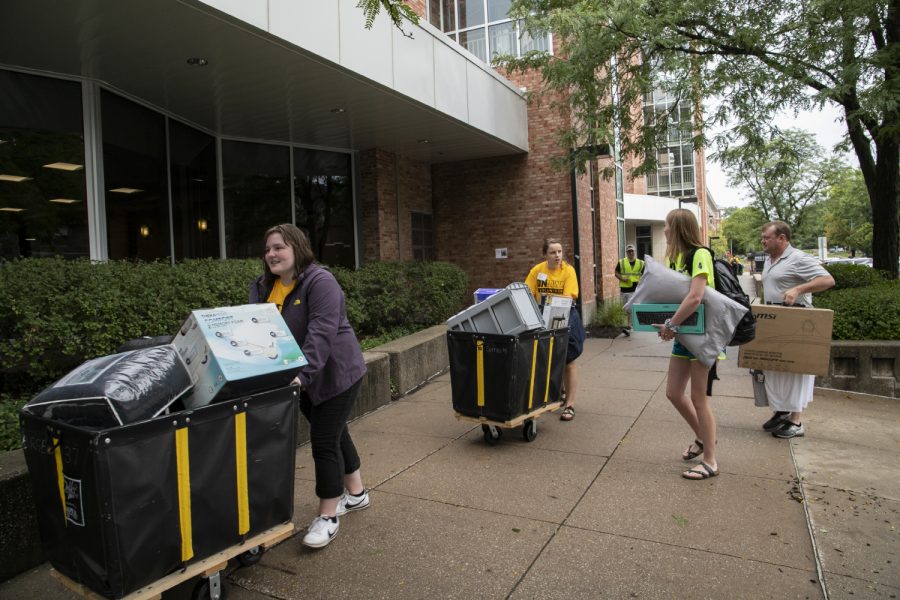 On-Iowa volunteers help a family move items into Burge Hall during move-in on Tuesday, August 20, 2019. 