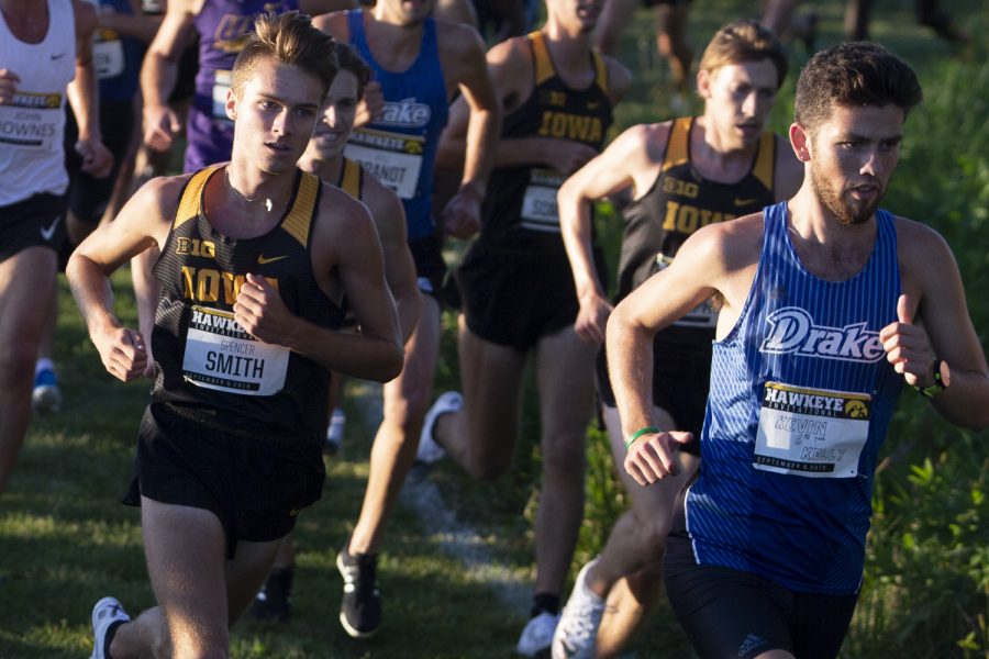 The University of IowaÕs Spencer Smith attempts to pass Drake UniversityÕs Kevin Kelly during the Hawkeye Invitational on Friday, Sept. 6, 2019 at the Ashton Cross Country Course. The Hawkeyes prevailed over six other teams to win first place overall in the menÕs and womenÕs races. Smith finished in 7th place with a time of 18:25.3, while Kelly placed 14th overall.