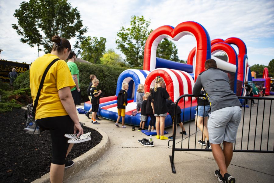 Parents watch their little Hawkeyes play in an inflatable obstacle course outside of Kinnick Stadium on Sept. 7. 