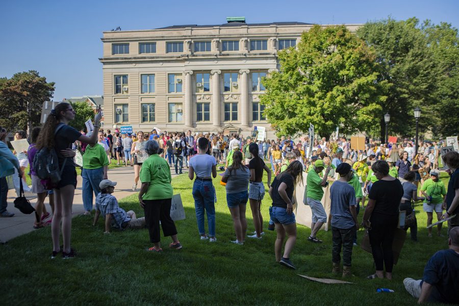 A crowd of hundreds gathers on the Pentacrest lawn to raise awareness about climate change. The Iowa City Climate Strike march was one of hundreds taking place around the world on Friday, Sept. 20. (Reba Zatz/The Daily Iowan)