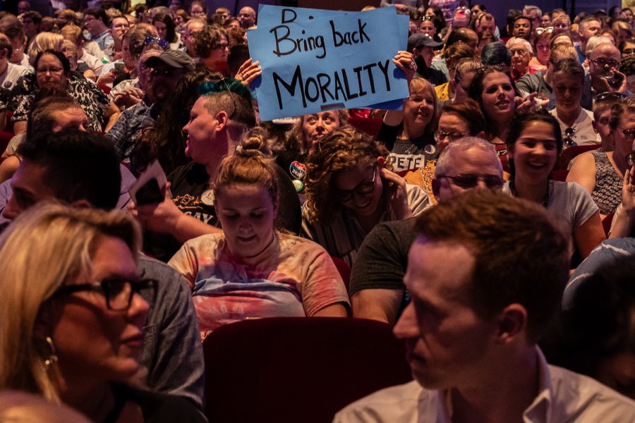 An attendee holds a sign before the L.G.B.T.Q. Presidential Forum at the Sinclair Auditorium in Cedar Rapids on Friday, September 20, 2019. Each candidate that participated was gave a three minute introduction, and answered questions for a total of ten minutes. 
