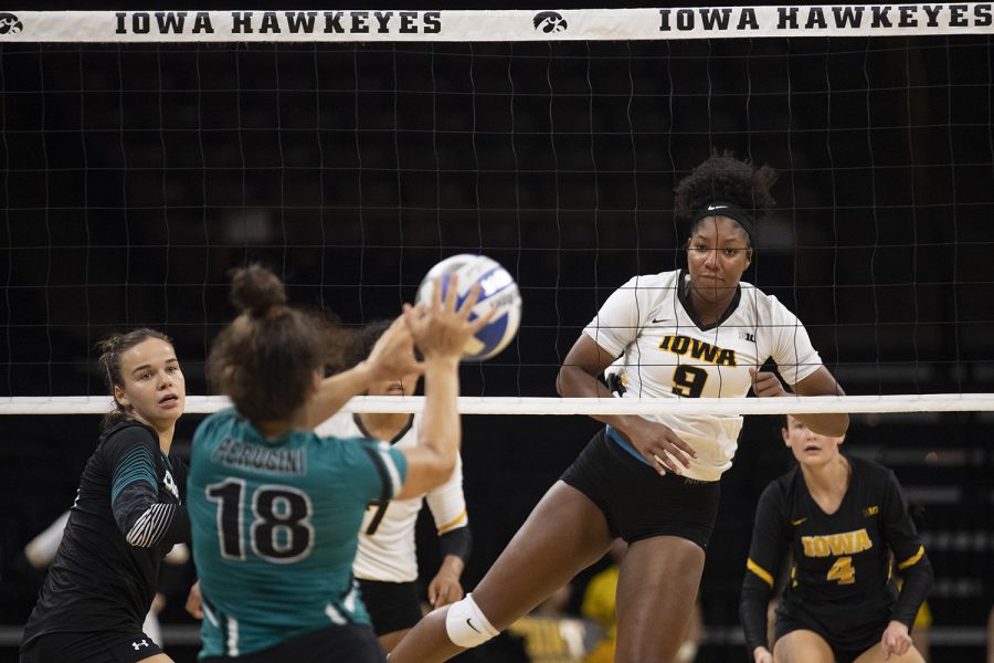 Iowa middle blocker Amiya Jones watches Coastal Carolina’s Perugini respond to a spike at a volleyball game against Coastal Carolina at Carver Hawkeye Arena on Friday, September 20, 2019. The Chanticleers defeated the Hawkeyes 3-1.