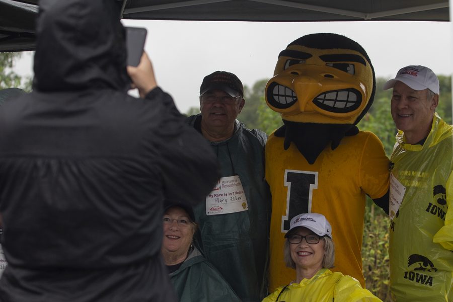 Herkey poses for a photo with participants and volunteers at the registration table during the 2019 Iowa Miles for Myeloma Run/Walk at Terry Trueblood Recreation Area on Sunday, September 22, 2019. 