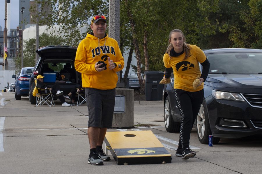 David and Morgan Aitchison play a game of bags at their tailgate in the Main Library Parking Lot before the Iowa football game against Middle Tennessee State University on Saturday, Sept. 28, 2019.