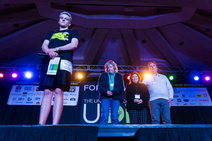 Then-Dance Marathon Executive Director Charlie Ellis stands on stage with Mollie Tibbetts parents Laura Calderwood and Rob Tibbetts during a moment of silence dedicated to Mollie, a former Dance Marathon participant, during the organizations Big Event in February 2019.