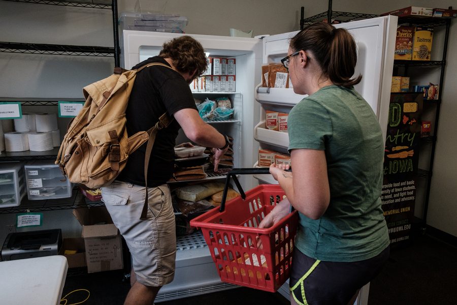 Cathryn and her husband Dylan pick up food from the food pantry in the Iowa Memorial Union on Tuesday, September 10, 2019. Cathryn is a senior graduate student and Dylan is an artist. Using the food pantry helps them save money on groceries so they can put money towards other expenses. 