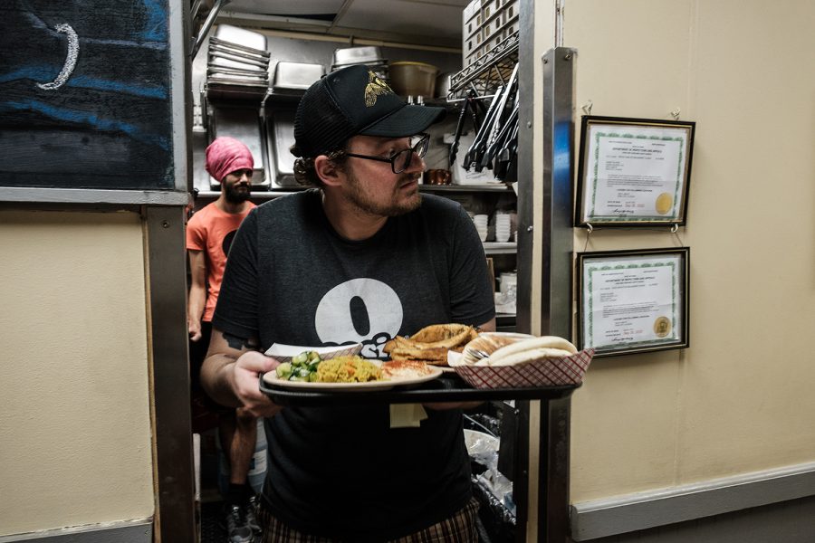Oasis manager Joe Kapp runs an order to a customer on Monday, September 30, 2019. As of October 1, Oasis has been open for fifteen years. To celebrate, they’re donating a portion of their sales to a different non profit organization in Iowa City for the first fifteen days of October.