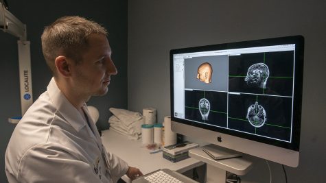 University of Iowa researcher Nicholas Trapp is operating a monitor for his Transcranial Magnetic Stimulation system on Friday, September 13th, 2019. Nicholas and his team is studying transcranial magnetic stimulation (TMS) and how effective the treatment would be in the cases of bipolar disorder, autism, and schizophrenia.