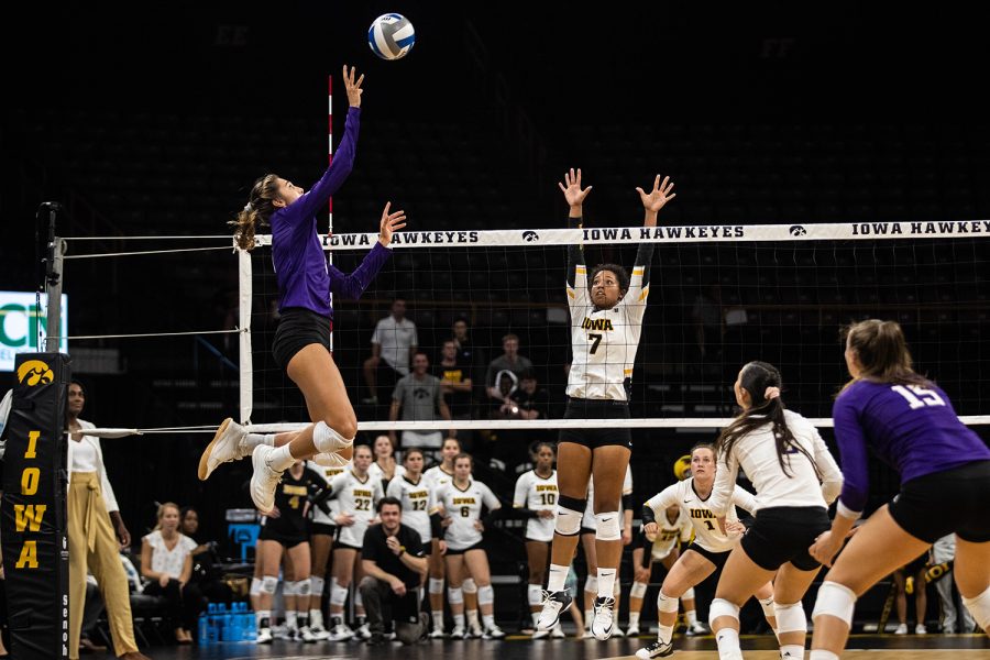 Iowa setter Brie Orr jumps to block a kill during a volleyball match between Iowa and Washington at Carver Hawkeye Arena on Saturday, September 7, 2019. The Hawkeyes were defeated by the Huskies, 3-1.