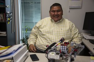 Tracy Peterson poses for a portrait with a student’s STEM project in his office at the Seamen Center on Thursday, Sept. 12, 2019. Peterson will be leaving his job as Diversity Director for the College of Engineering to move to Penn State.