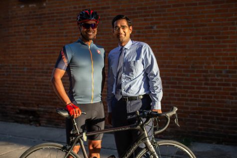 Ashish Mishra and Varun Monga pose for a portrait in downtown Iowa City on Thursday. The pair met through cycling when Mitra biked 1,000 miles across Iowa to raise money for sarcoma.