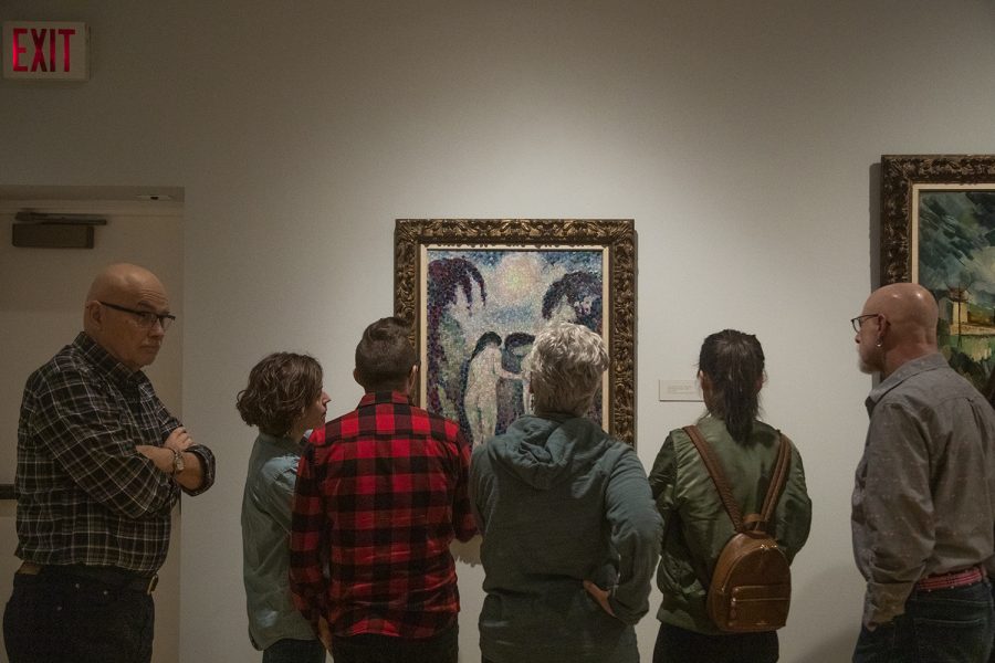 Attendees observe Jean Metzingers Two Nudes in a Garden during a Pointillism workshop at the Stanley Art Museum on Saturday March 9. The event was a collaboration between the art and theater department. 