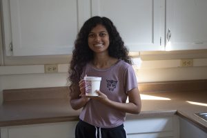 Sugar Fiend Sweets owner Ramya Kolusu poses for a portrait with a pint of her Black & Gold ice cream in the kitchen of the Bedell Entrepreneurship Learning Laboratory on Friday, Sept. 20, 2019. Kolusu is in her final semester at the University of Iowa and was inspired to start her own ice cream business by a now-closed ice cream shop in her hometown, Clinton, Iowa. She began making her own ice cream approximately three years ago after learning from videos online.