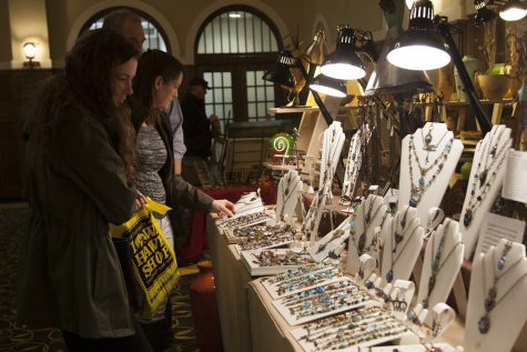 A family looks at jewelry during the Spring Art Expose in the IMU Main Lounge on Saturday Apr. 21, 2018. Put on by the UI Fine Arts Council, the Spring Art Expose celebrates local artists.