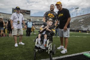 Kid Captain Cien Currie and his father pose for a picture Hawkeye Football Head Coach Kirk Ferentz at Kids Day at Kinnick on Saturday, August 10, 2019. Kids Day at Kinnick is an annual event for families to experience Iowas football stadium, while watching preseason practice and honoring this years Kid Captains. 