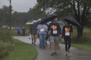 Participants fend off the rain during the 2019 Iowa Miles for Myeloma Run/Walk at Terry Trueblood Recreation Area on Sunday, September 22, 2019. 