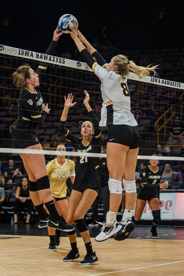 Iowa outside hitter Kyndra Hansen (8) blocks the ball during a volleyball match between Iowa and Colorado in Carver-Hawkeye Arena on Friday, September 6, 2019. The Hawkeyes dropped their season opener to the Buffaloes, 3-0.