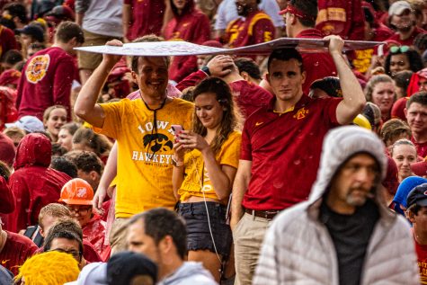 Spectators sit in the rain during a football game between Iowa and Iowa State at Jack Trice Stadium in Ames on Saturday, September 14, 2019. The Hawkeyes retained the Cy-Hawk Trophy for the fifth consecutive year, downing the Cyclones, 18-17.