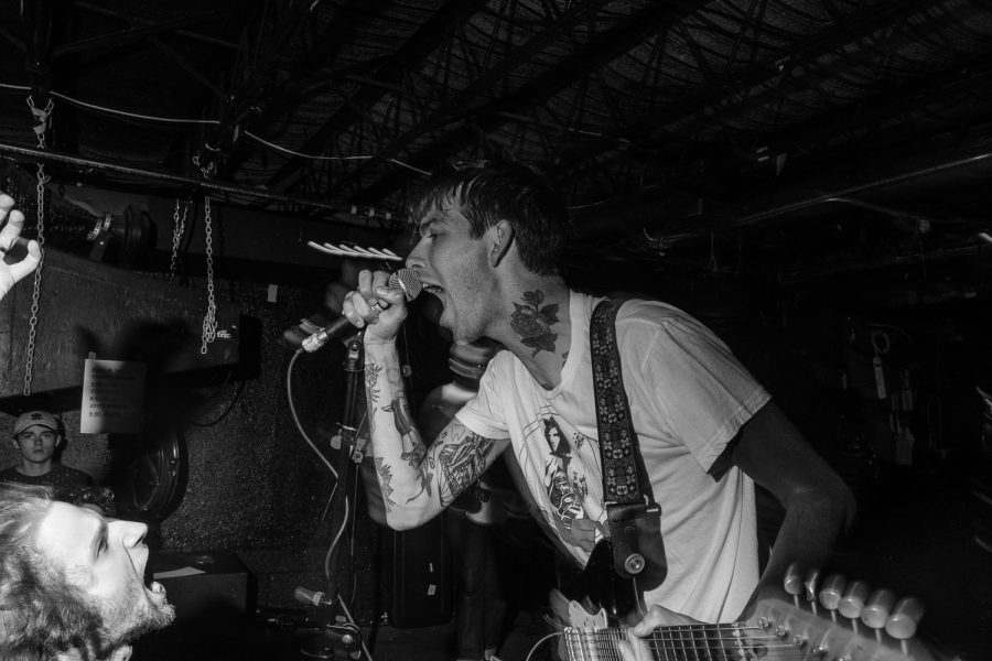 Vocalist and guitarist Barry Johnson sings into a microphone during a Joyce Manor concert at Gabe’s in Iowa City on Wednesday, October 9, 2019. Joyce Manor is a punk band from Torrance, California.
