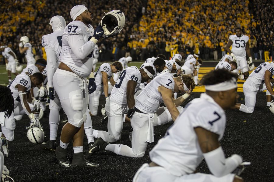 Lions kneel on the field before the Iowa football vs. Penn State game in Kinnick Stadium on Saturday, Oct. 12, 2019. The Nittany Lions defeated the Hawkeyes 17-12. 