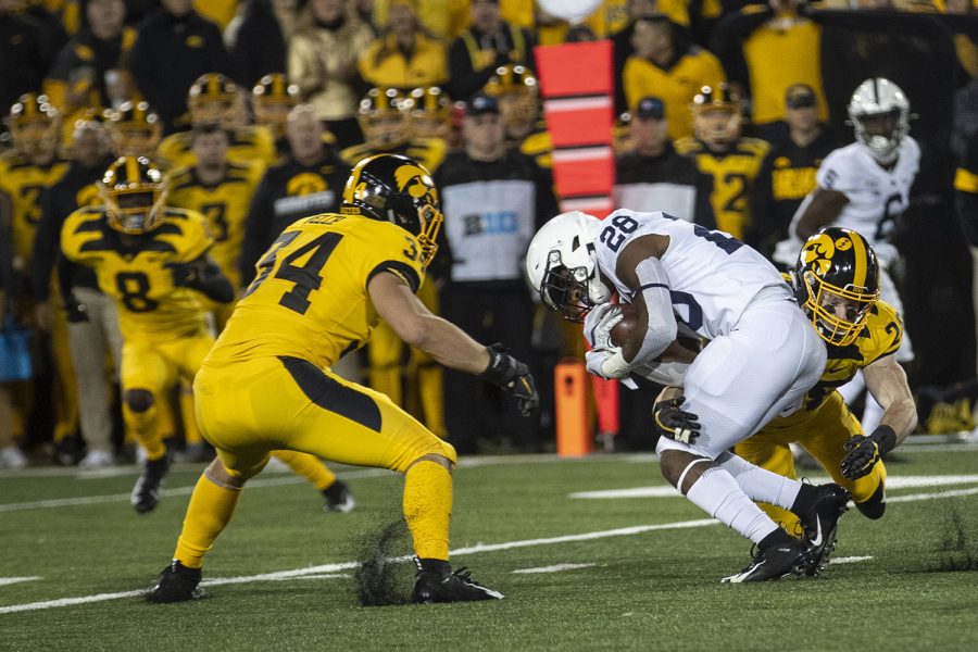 Penn State DE Jayson Oweh is tackled during the Iowa football vs. Penn State game in Kinnick Stadium on Saturday, Oct. 12, 2019. The Nittany Lions defeated the Hawkeyes 17-12. 