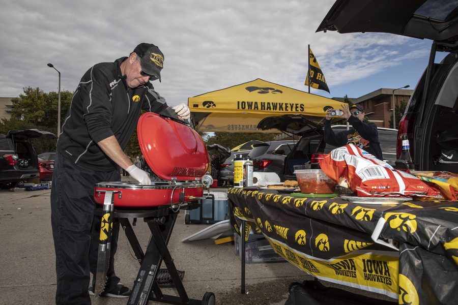 Franz Gramenz of Iowa City cleans his grill during the tailgate before the Iowa-Penn State football game on October 12, 2019. The Hawkeyes are currently 4-1 after a loss to Michigan on the road last Saturday. 