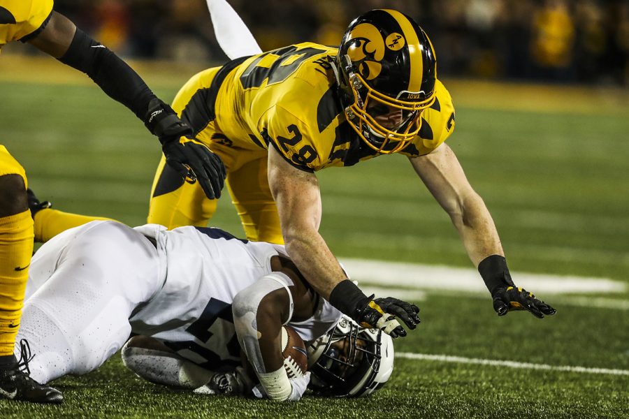 Iowa defensive back Jack Koerner flies over Penn State running back Devyn Ford during the Iowa football game against Penn State in Iowa City on Saturday, Oct. 12, 2019. The Nittany Lions defeated the Hawkeyes 17-12.