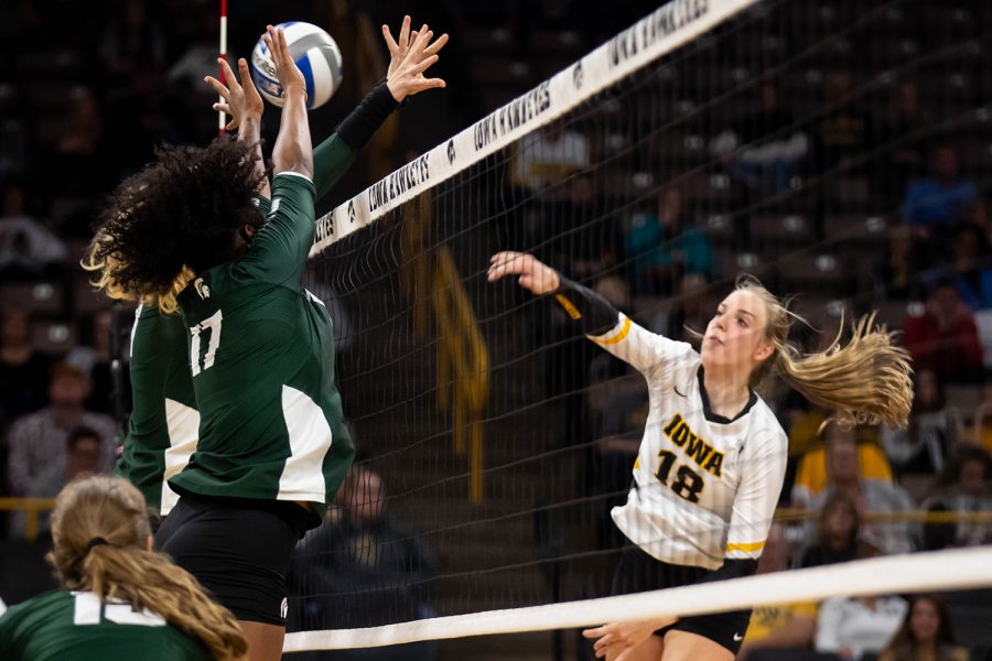 Iowa middle blocker Hannah Clayton spikes the ball during a volleyball match between Iowa and Michigan State at Carver Hawkeye Arena on Sunday, October 12, 2019. The Hawkeyes were defeated after 5 sets.