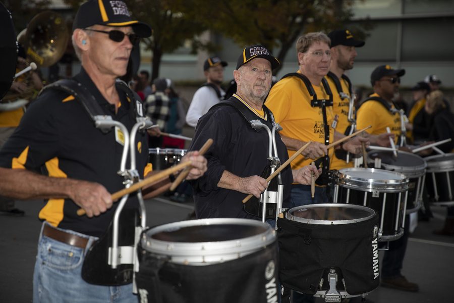 Members of the Alumni Band play snare drums during the University of Iowa Homecoming Parade through downtown Iowa City on Friday, Oct. 18, 2019.