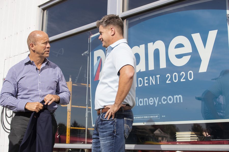 2020 Democratic Candidate and former Maryland Congressman John Delaney speaks to business owner Jason Hall outside Moxie Solar in North Liberty, IA, on Friday, Oct. 18, 2019. The visit was part of John Delaney’s Heartland Startup Tour. (Jenna Galligan/The Daily Iowan)