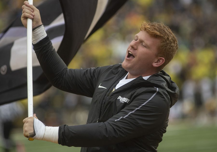 A member of the Purdue cheer squad waves a flag in front of the Iowa student section after Purdue scored a touchdown during the fourth quarter of the Iowa football game against Purdue at Kinnick Stadium on Saturday, Oct. 19, 2019. The Hawkeyes defeated the Boilermakers 26-20. 