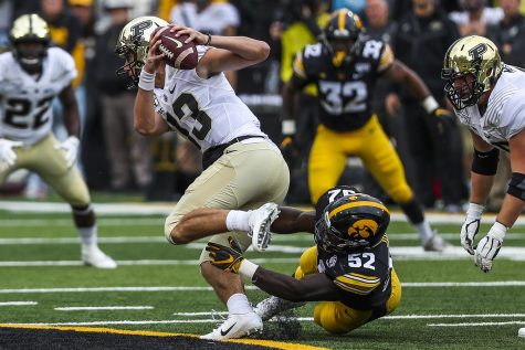 Iowa linebacker Amani Jones attempts to tackle Purdue quarterback Jack Plummer during the Iowa football game against Purdue at Kinnick Stadium on Saturday, Oct. 19, 2019. The Hawkeyes defeated the Boilermakers 26-20.