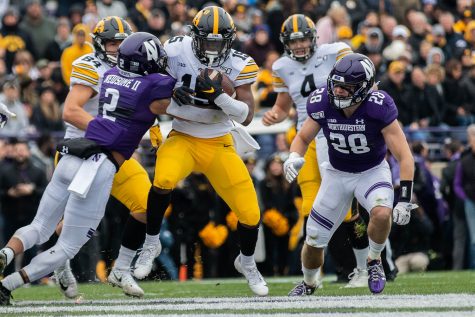 Iowa running back Tyler Goodson breaks a tackle during a game against Northwestern at Ryan Field on Saturday, October 26, 2019. The Hawkeyes defeated the Wildcats 20-0. Goodson rushed for a total of 58  yards. 